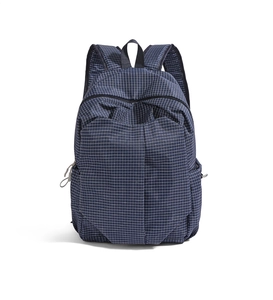 Close-up of navy blue plaid waterproof nylon backpack with white grid pattern and pockets