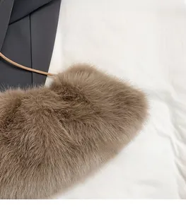 Close-up of soft brown faux fur material on a stylish crossbody bag with drawstring