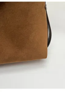 Close-up of caramel suede tote bag showcasing fine stitching and matte texture details