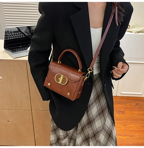 Brown vintage square bag with gold lock buckle styled with a plaid skirt and blazer