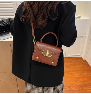 Detail of vintage brown quilted handbag with gold hardware and studded corners