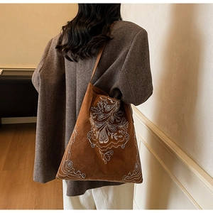 Detailansicht der braunen Wildleder-Tragetasche mit weißer Blumenstickerei im Vintage-Stil