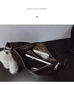 Interior view of the dark brown shoulder bag showing main compartment and side pockets