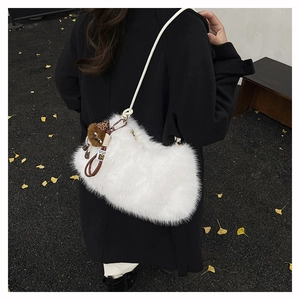 Close-up of white plush shoulder bag with leopard print charm on a dark autumn coat