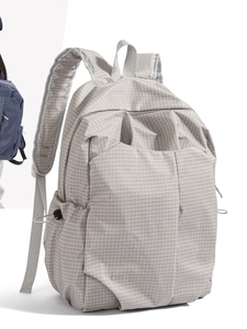 Light grey grid pattern laptop backpack with multiple pockets and side drawstrings