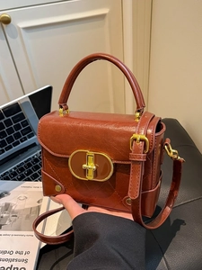 Retro reddish brown crossbody bag with gold oval lock and elegant top handle for work