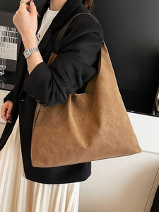 Minimalist brown matte leather large tote bag for women shown on shoulder in daily use