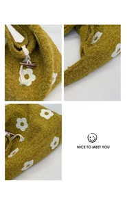 Detail of olive green plush tote bag featuring floral embroidery and horn button closure