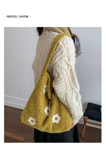 Detailed texture of mustard yellow plush tote bag with white flower embroidery details