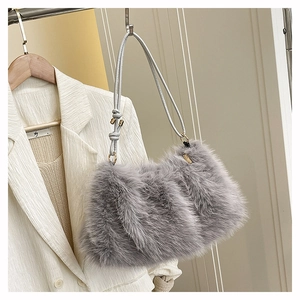 Detail of grey fluffy faux fur tote bag with knotted leather strap and golden hardware