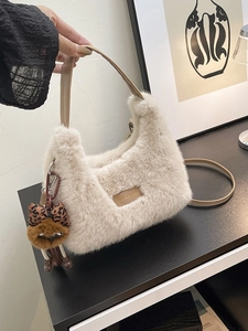 Elegant apricot plush dumpling bag with leather handle and decorative leopard bow charm