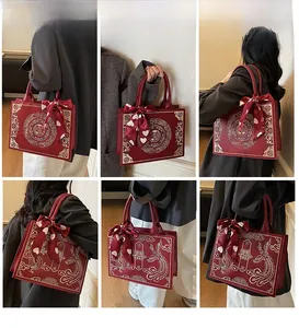 Detail view of red bridal tote bag with traditional Chinese embroidery and silk scarf handle