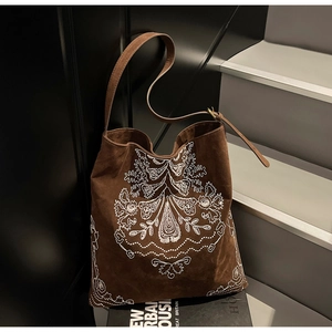 Detail der Stickerei auf großer dunkelbrauner Wildledertasche mit Paisley-Mustern