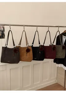 Selection of five stylish tote bags in matte faux leather with fluffy pompom charms