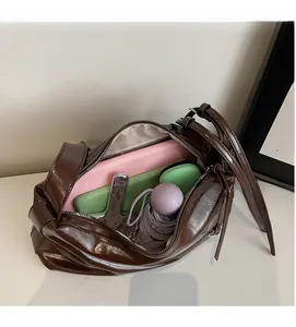 Deep brown tote bag showing large interior capacity with gadgets and umbrella