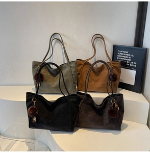 Detail view of large faux leather tote bags in four retro colors with plush charms