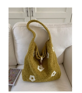 Detail of mustard yellow plush tote bag with white flower embroidery and wooden bead drawstring