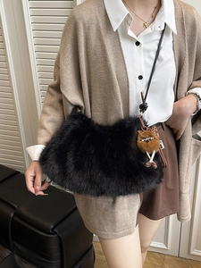 Plush faux fur hobo bag in black with fuzzy cartoon pendant for autumn winter outfits