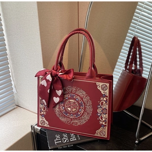Macro shot of traditional red bridal handbag with golden embroidery and囍symbol