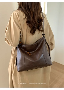 Détail d'un cabas rétro marron foncé avec des glands à franges et perles en bois