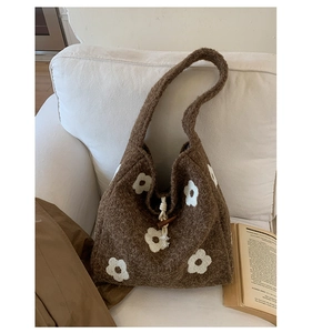 Close-up of vintage brown plush tote with white flower embroidery and wood toggle closure