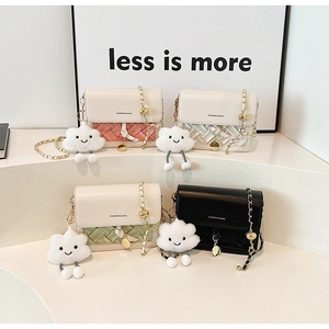 Close-up of stylish mini crossbody bags in four colors with woven texture and cloud charms