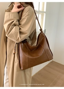Gros plan d'un sac hobo en cuir marron avec texture vintage et coutures verticales