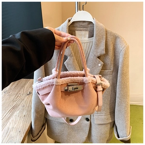 Detail of pink faux suede tote with shearling trim and metallic turn-lock closure