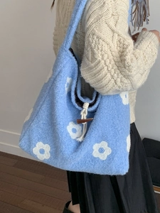 Blue plush tote bag with white flower embroidery and horn button closure for women