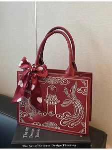 Red Chinese wedding handbag with golden dragon-phoenix embroidery and silk bow
