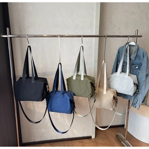 Selection of five durable nylon tote bags in various colors with adjustable shoulder straps