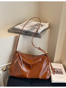 Vintage brown leather tote bag with a soft slouchy design and adjustable shoulder strap