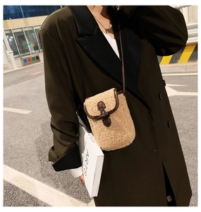 Detail of khaki lamb-fleece crossbody bag with dark brown leather trim and buckle