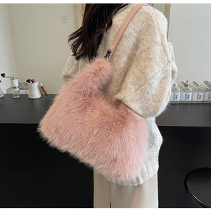 Detail view of a pink plush faux fur shoulder bag with leather strap and metal buckle