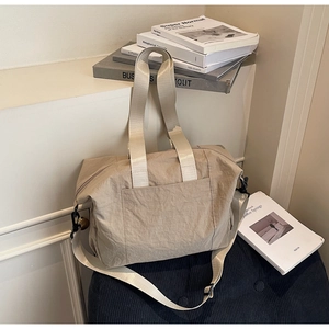 Detail view of large canvas tote bag with adjustable shoulder strap and durable metal buckles
