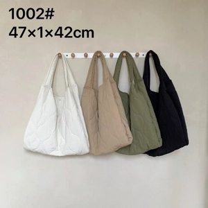 Quilted nylon tote bags in white khaki green and black showing waved texture details