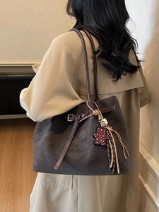 Vintage brown suede tote bag with leopard bear charm and fringe detail on model