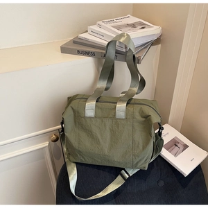 Close-up of military green large tote bag with adjustable strap and metallic hardware