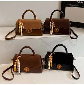 Detail of four retro flap bags with suede texture, gold twist locks and beaded charms