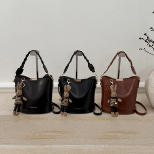 Detailed display of vintage bucket bags with woven handles and cute rabbit charms