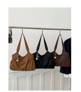Detailed comparison of three suede tote bags in caramel, black, and dark brown colors