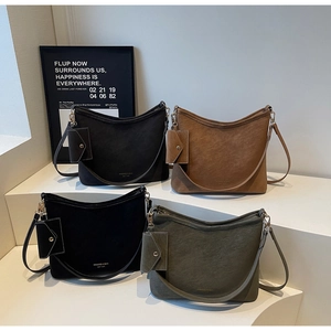 Close-up of retro crescent tote bags in four earthy colors with matching mini coin purses