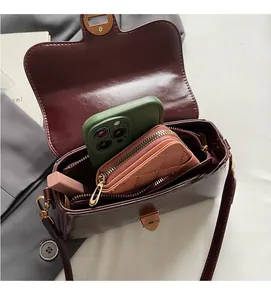 Interior view of burgundy leather handbag showing space for phone and cosmetics