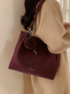 Burgundy faux suede oversized tote bag for women featuring a fuzzy pom-pom charm