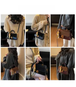 Detail of vintage tote bag showing matte leather patchwork and round metal twist lock
