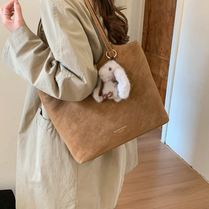 Brown suede tote bag with gold lettering and cute white rabbit plush charm detail