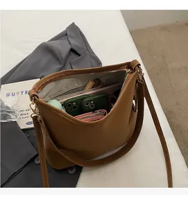 Interior view of large brown hobo bag showing spacious capacity for phone and wallet