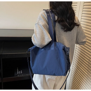 Deep blue nylon tote bag with double handles and detachable strap for daily commuting