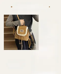 Detail of brown faux suede backpack featuring plush fleece trim and BEAR patch detail
