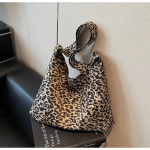 Detail of leopard print tote bag with adjustable wide strap and silver metal buckle